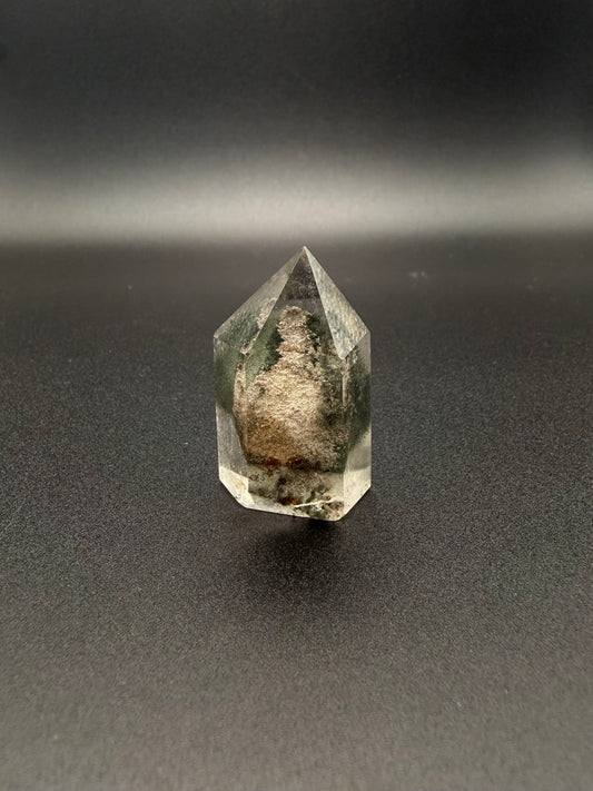 Polished garden quartz crystal tower with six sides.