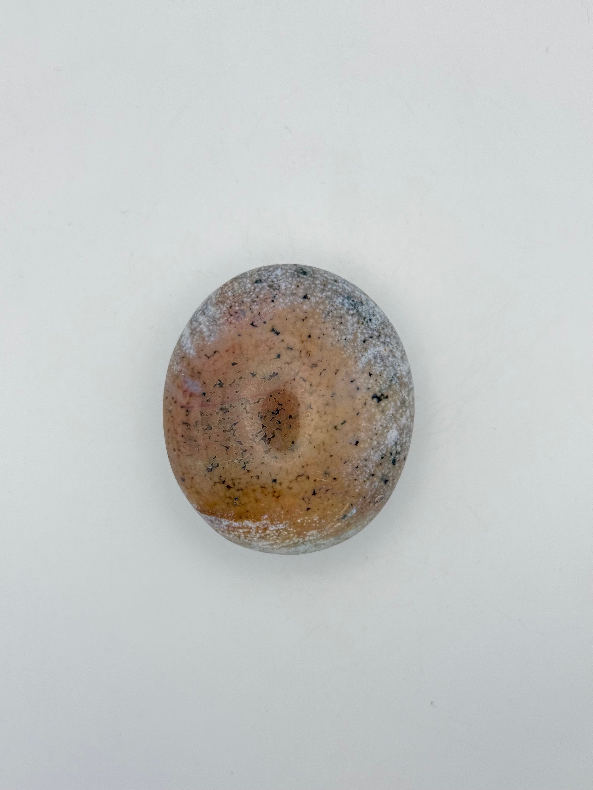 Polished ocean jasper palm stone.