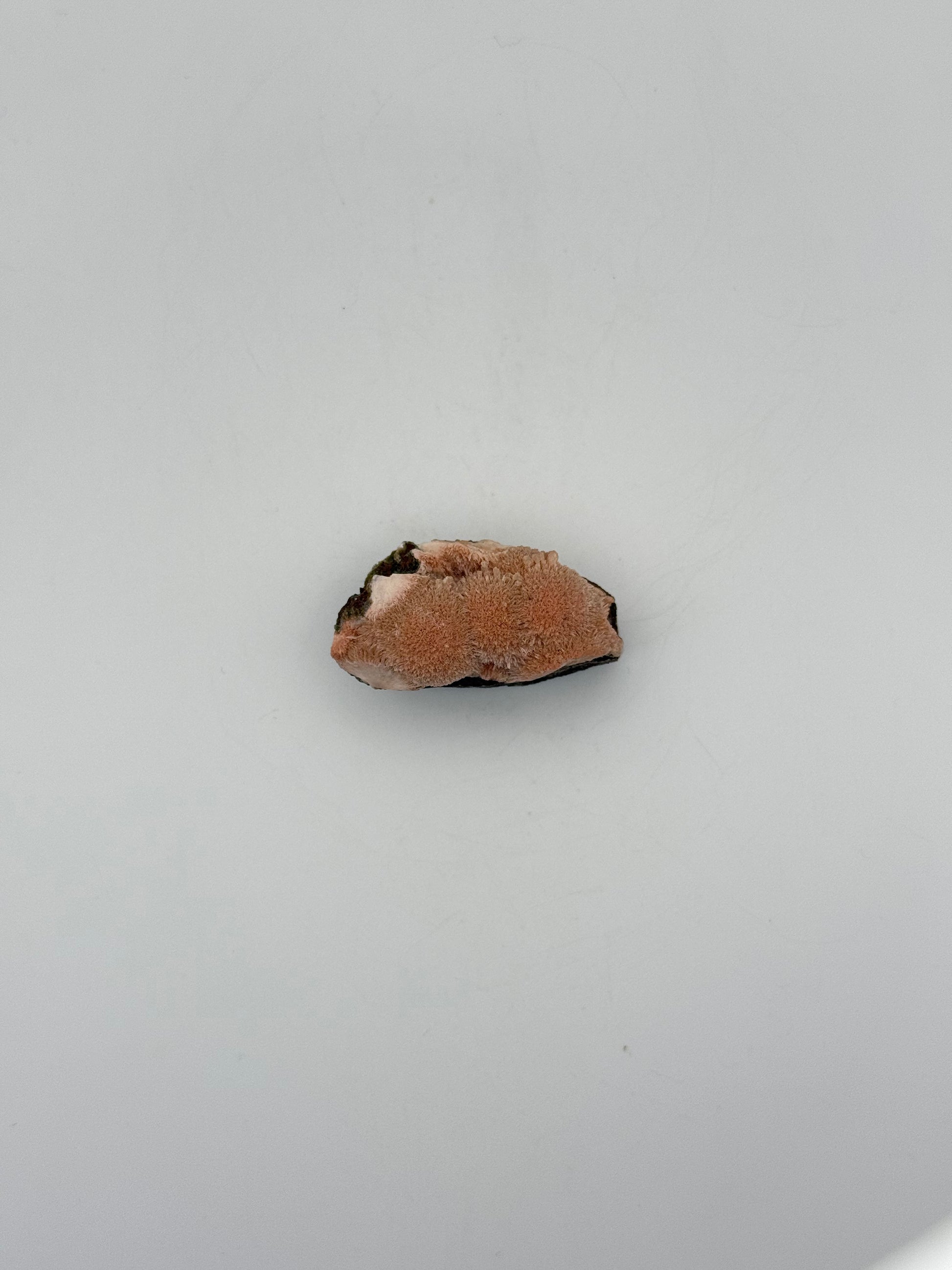 Raw Messolite crystal.