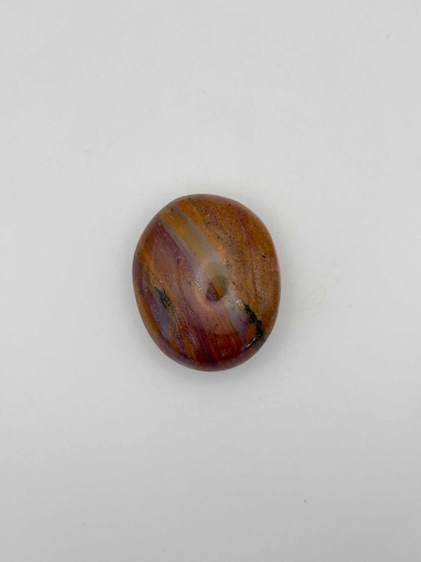Polished ocean jasper palm stone.