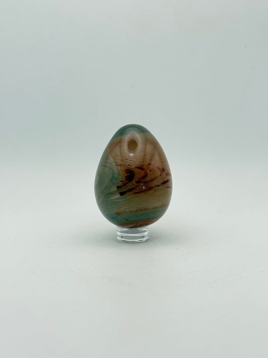 Polished polychrome jasper shaped into an egg.