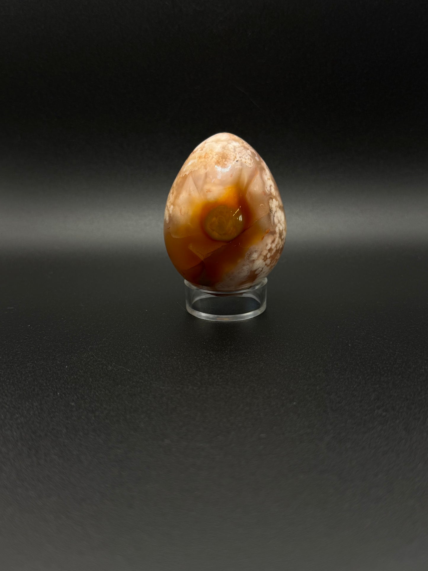Flower Agate polished crystal in the shape of an egg.