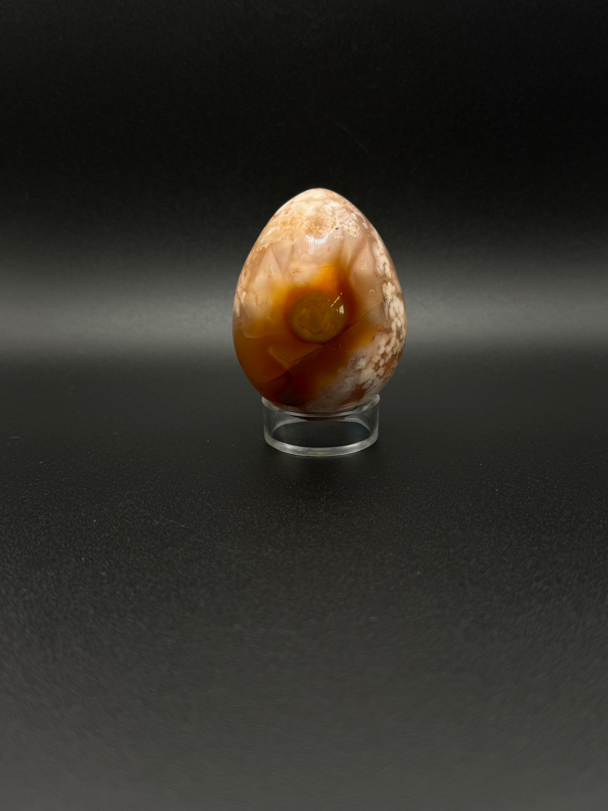 Flower Agate polished crystal in the shape of an egg.