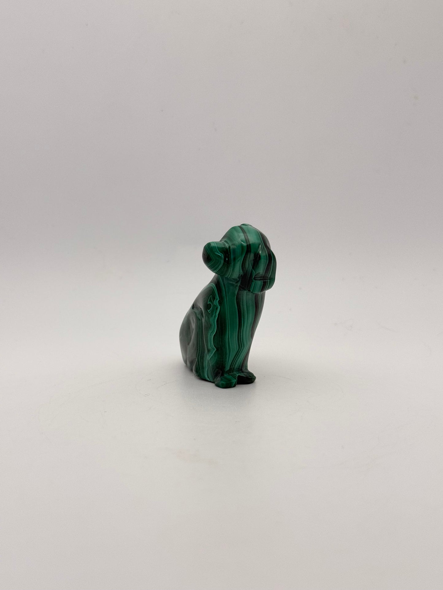 Polished malachite dog carving.