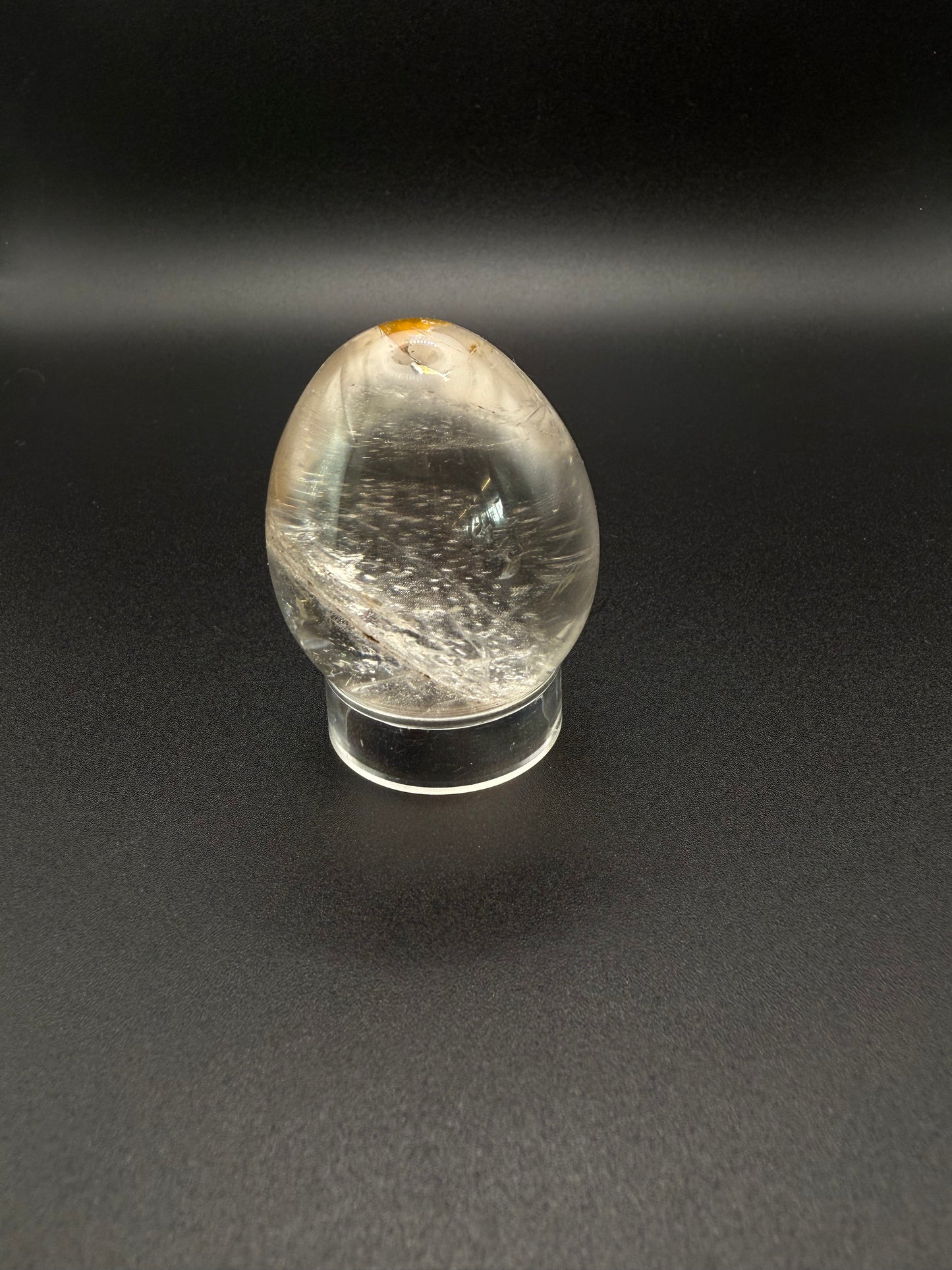 Clear quartz polished crystal thats egg shaped.