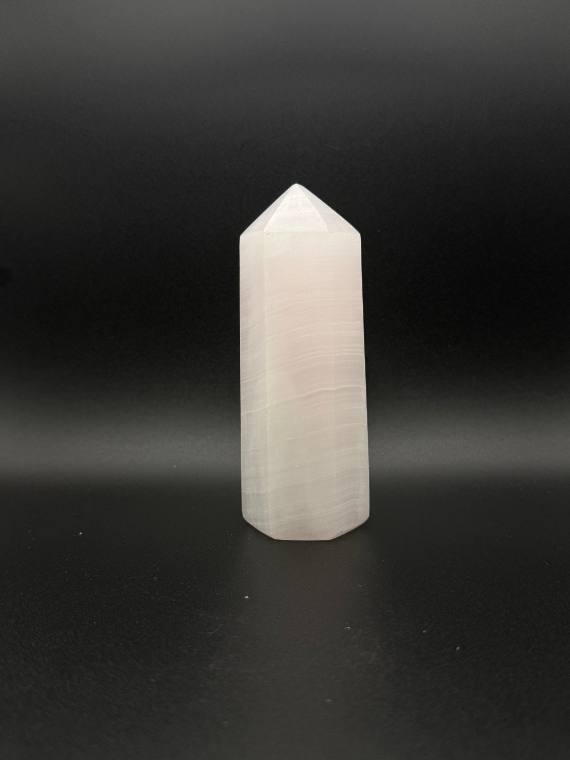 Polished pink calcite tower. Pink calcite glows under uv light.