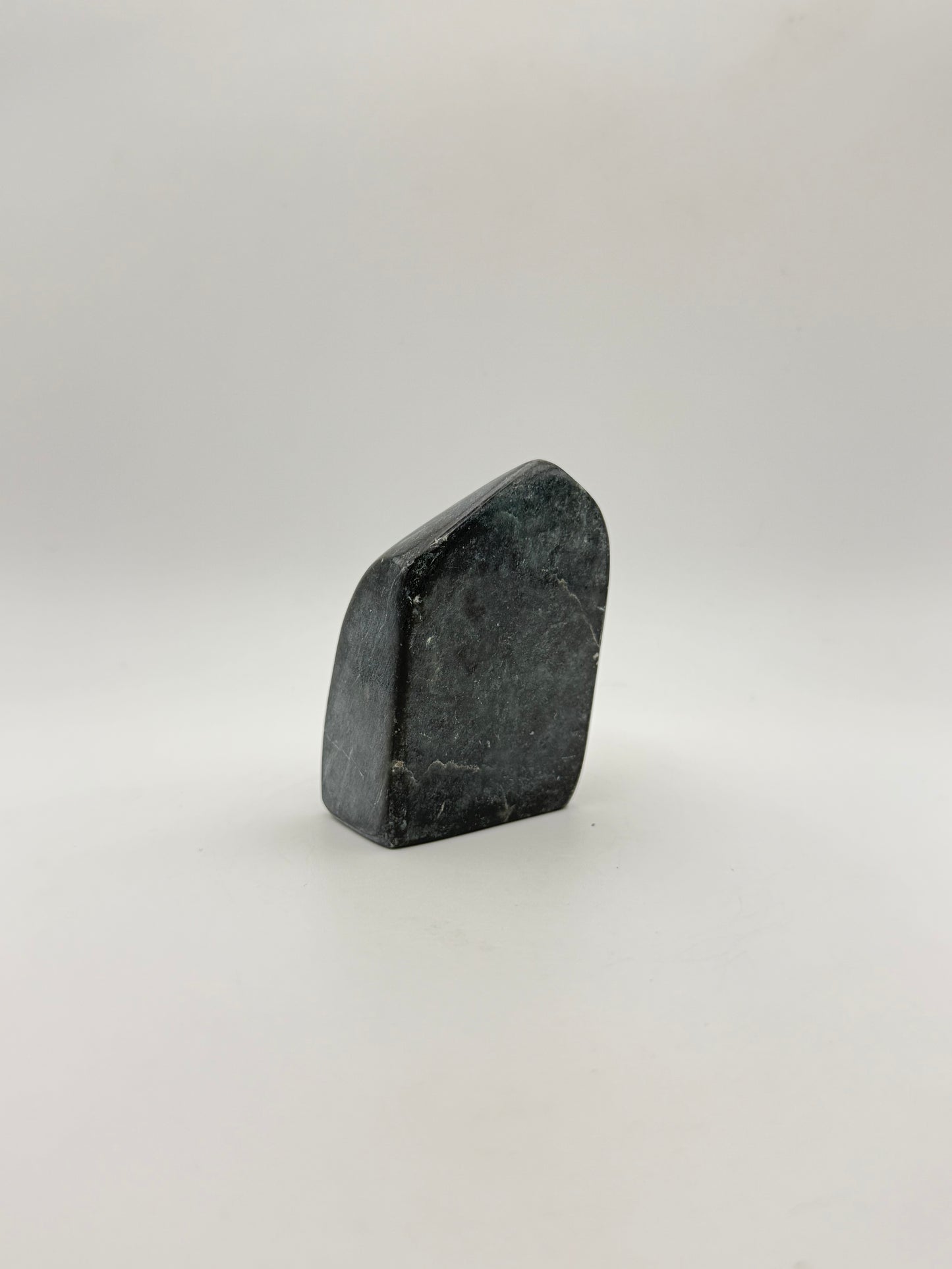 Polished green jade free form.
