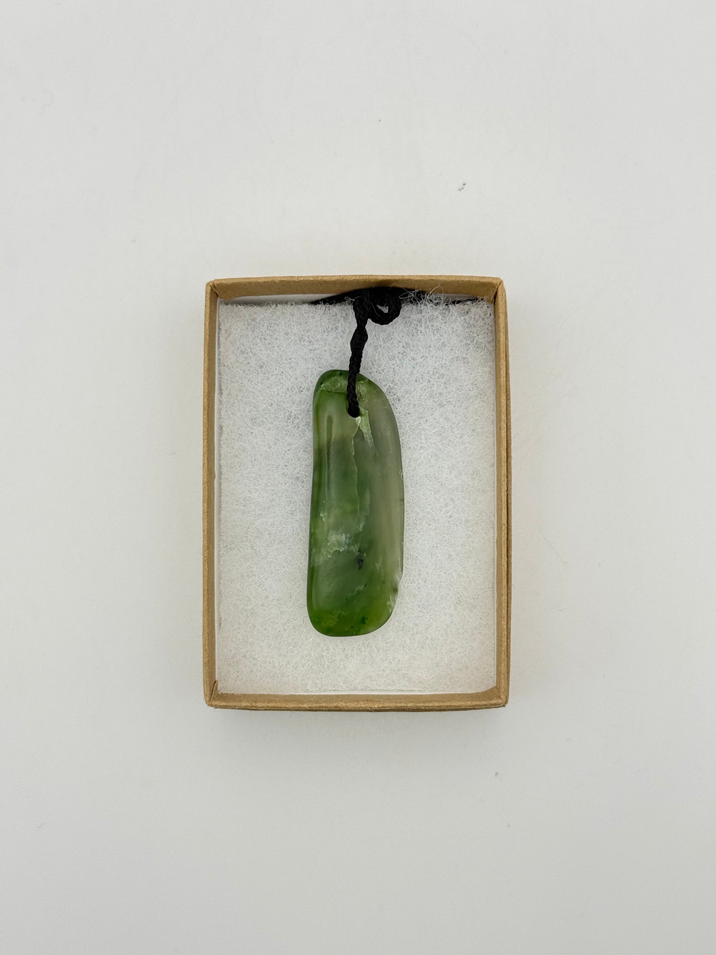 Green Jade pendant with string necklace.