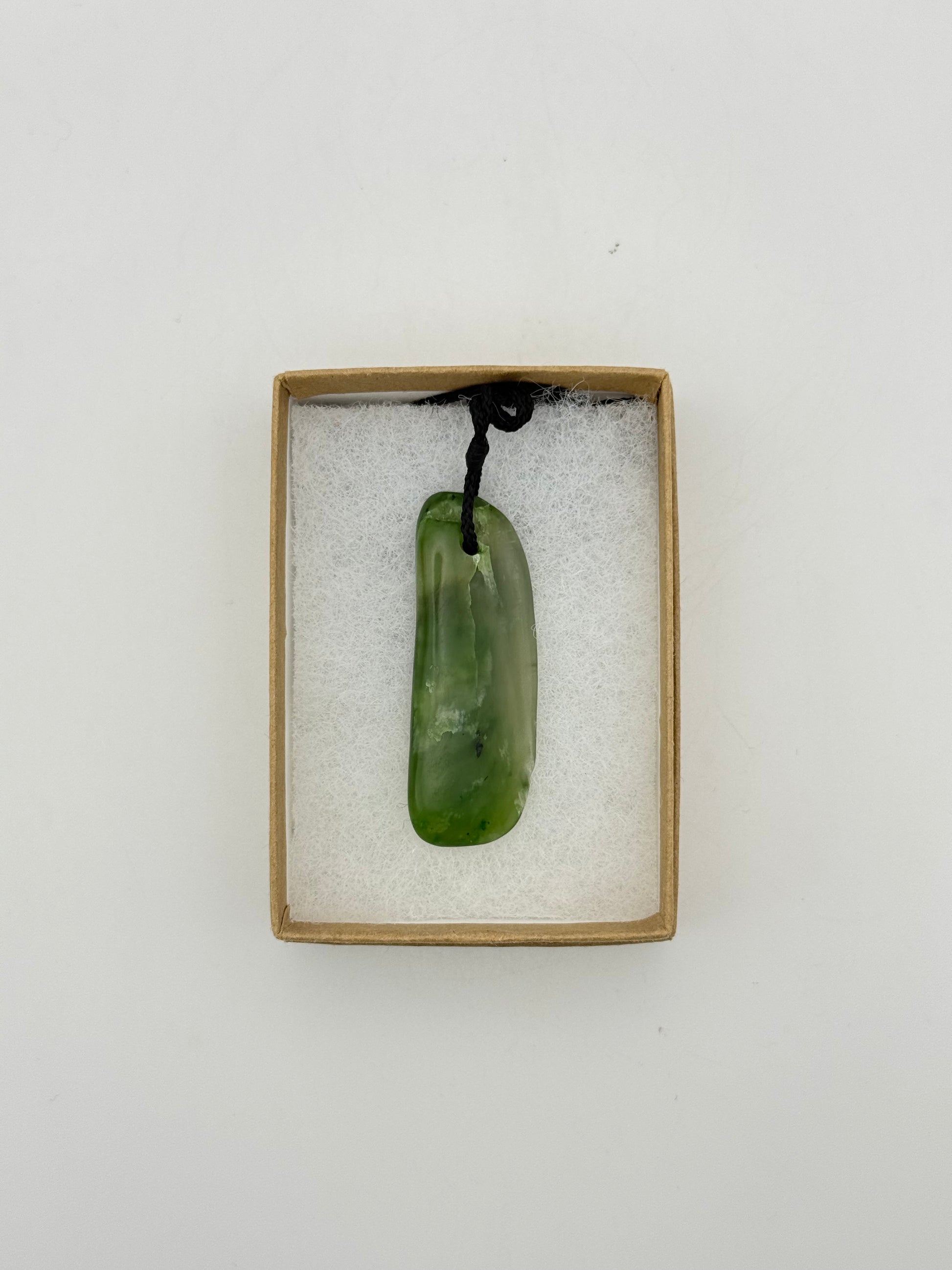 Green Jade pendant with string necklace.