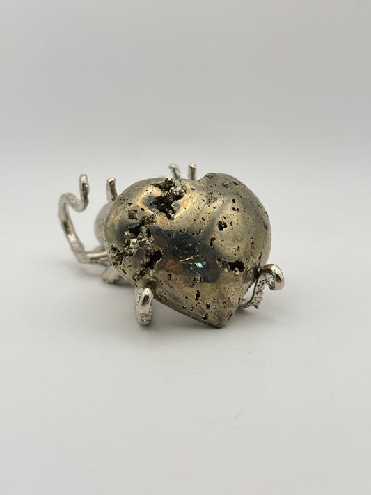 Polished pyrite crystal in the shape of a heart.
