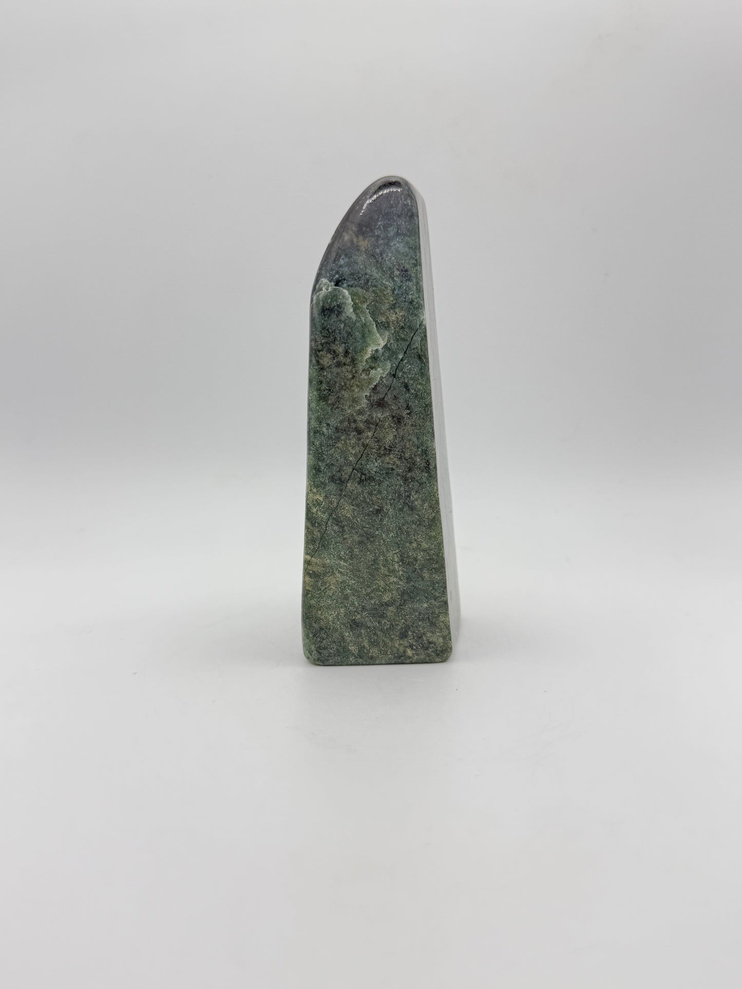 Polished green jade free form.