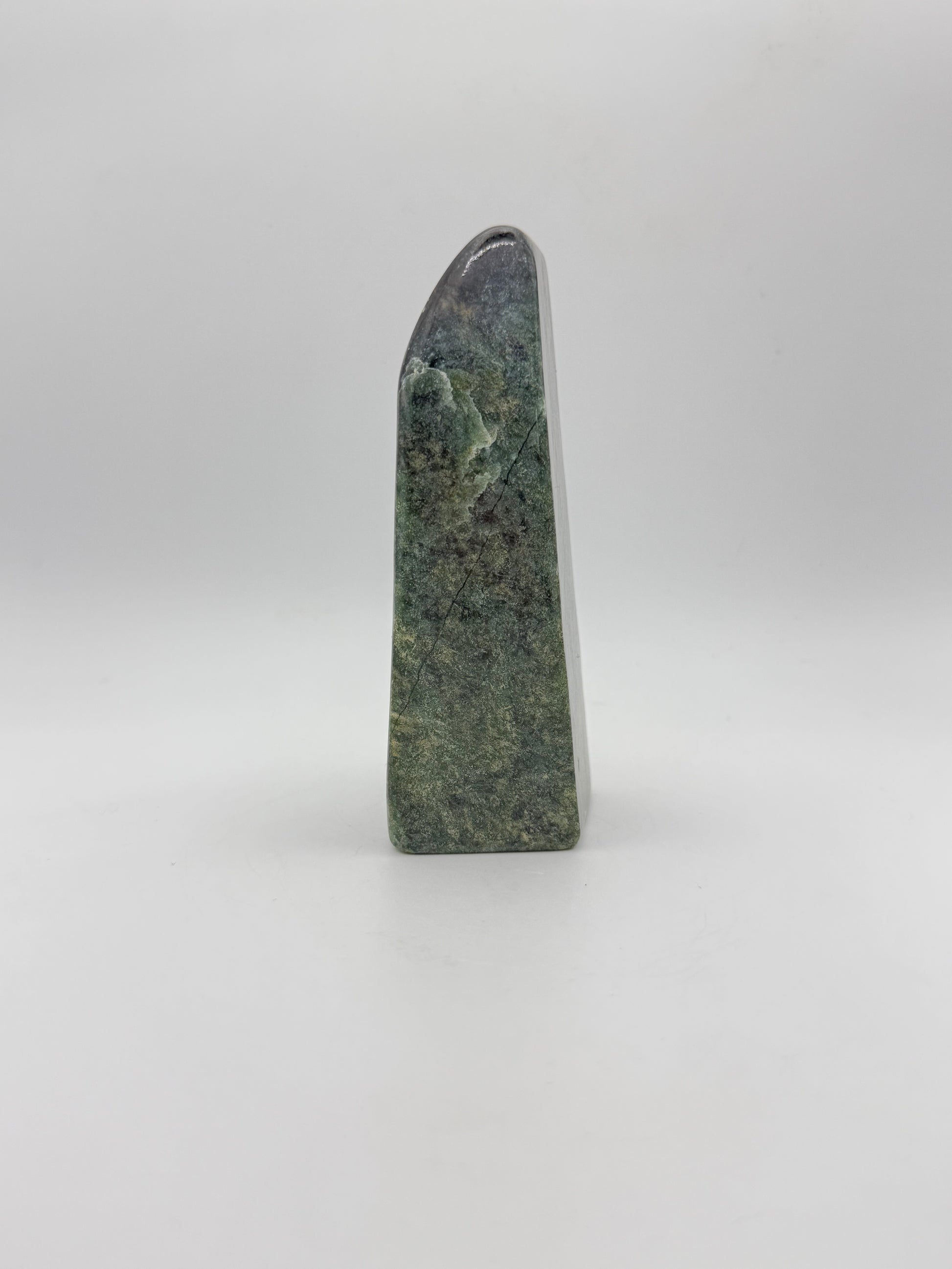 Polished green jade free form.