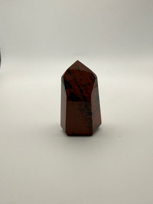 Polished mahogany obsidian tower with six sides.