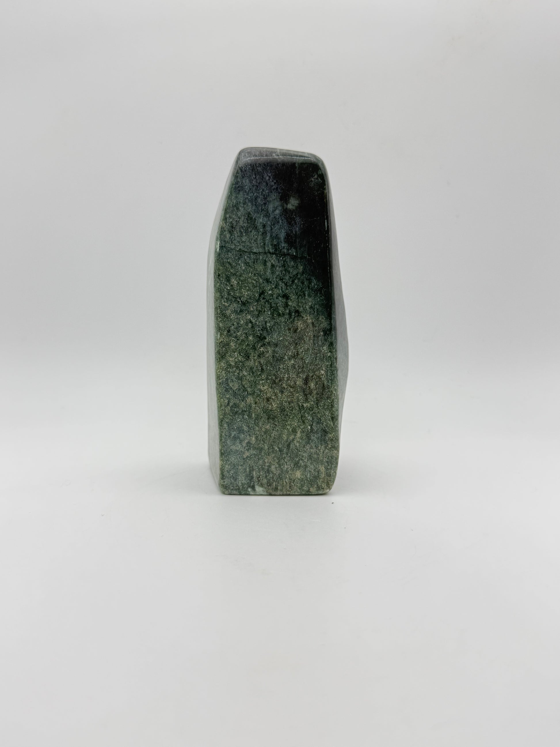 Polished green jade free form.