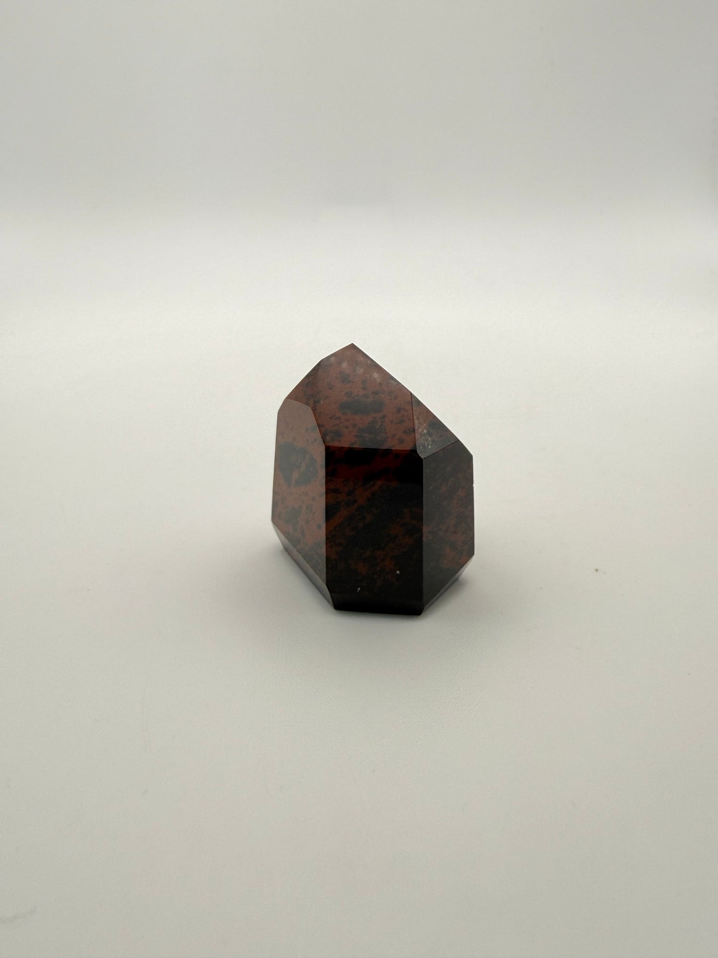 Polished mahogany obsidian tower with six sides.