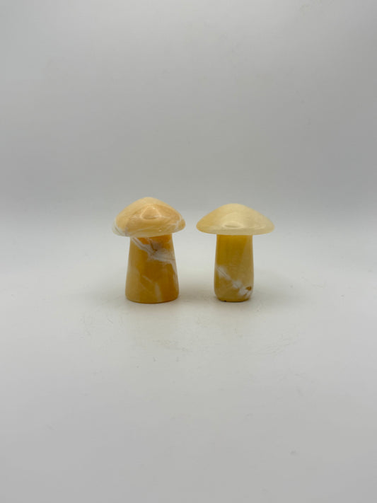Two orange calcite mushrooms.
