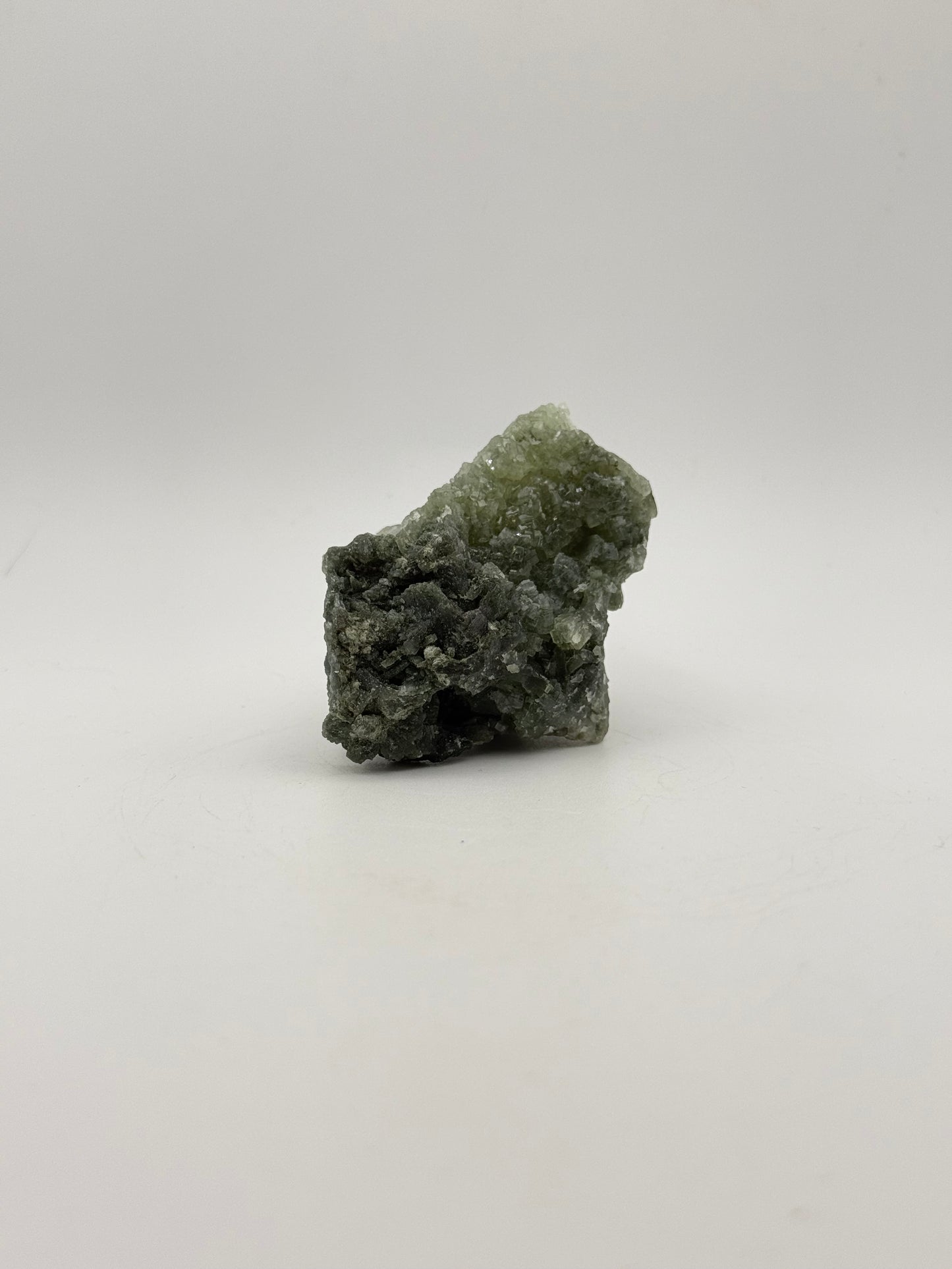 Raw prehnite specimen with good green coloring.