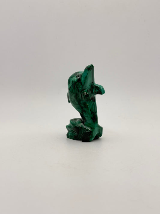 Polished malachite dolphin carving.