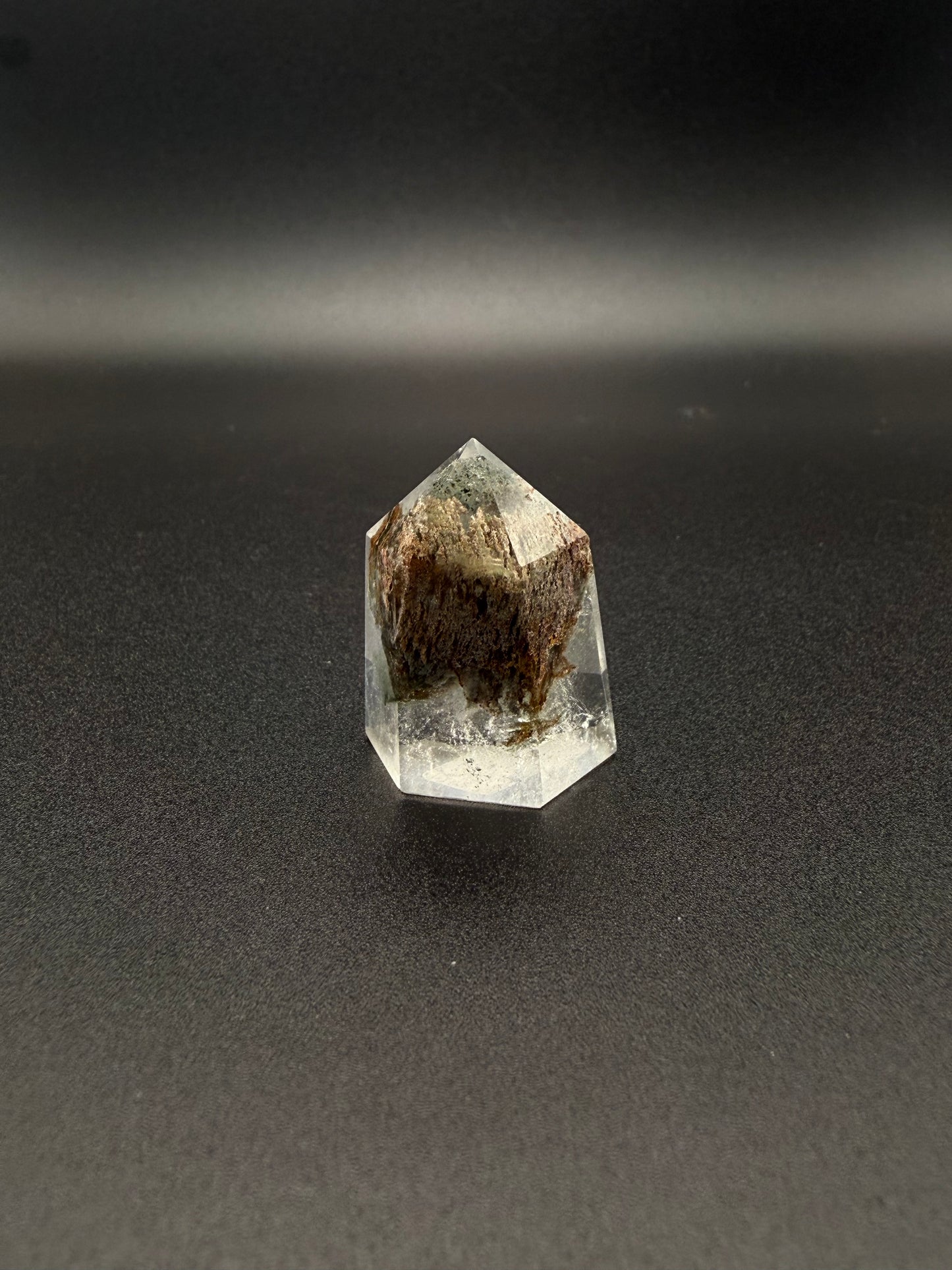 Polished garden quartz crystal tower with six sides.