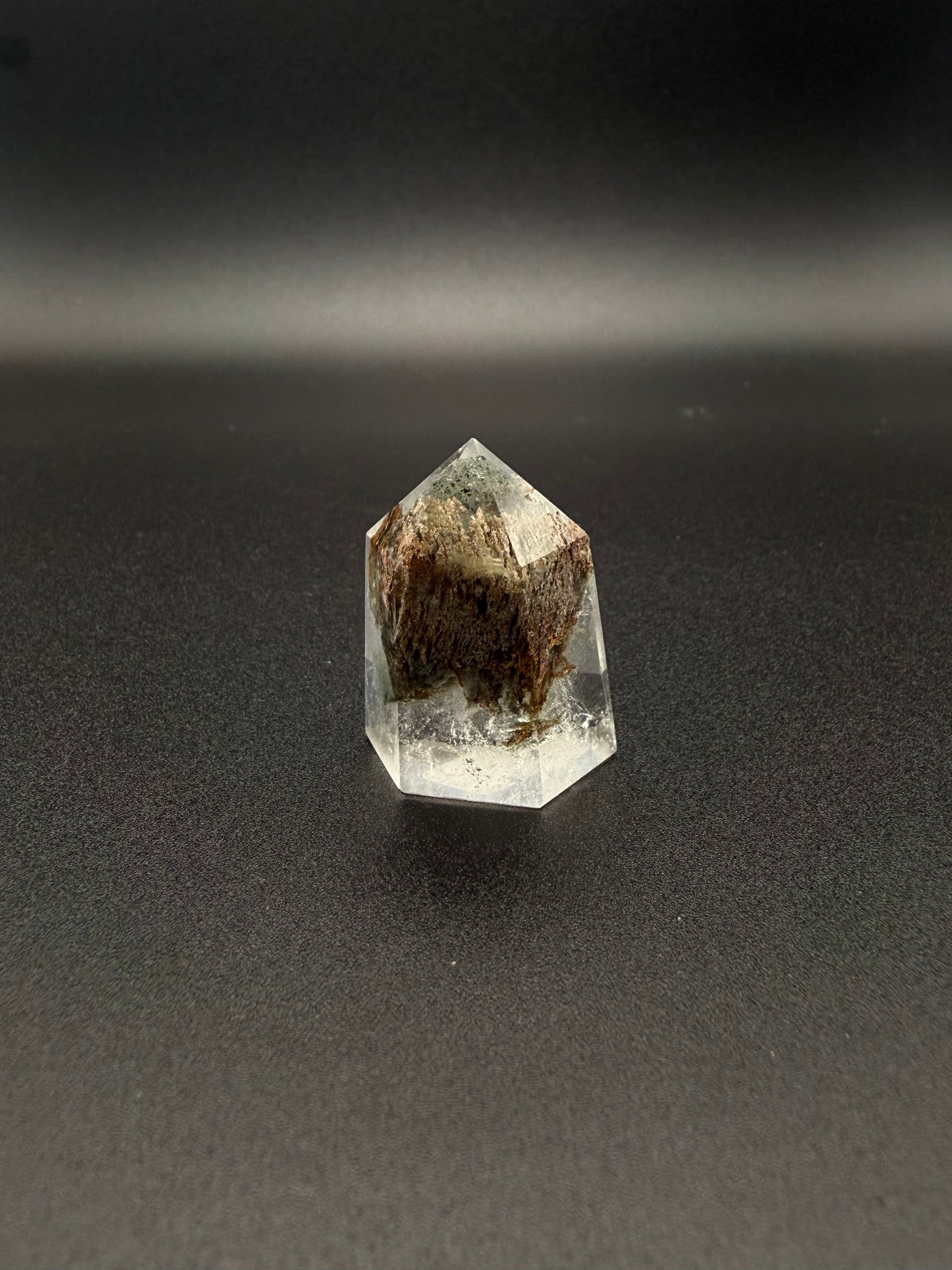 Polished garden quartz crystal tower with six sides.