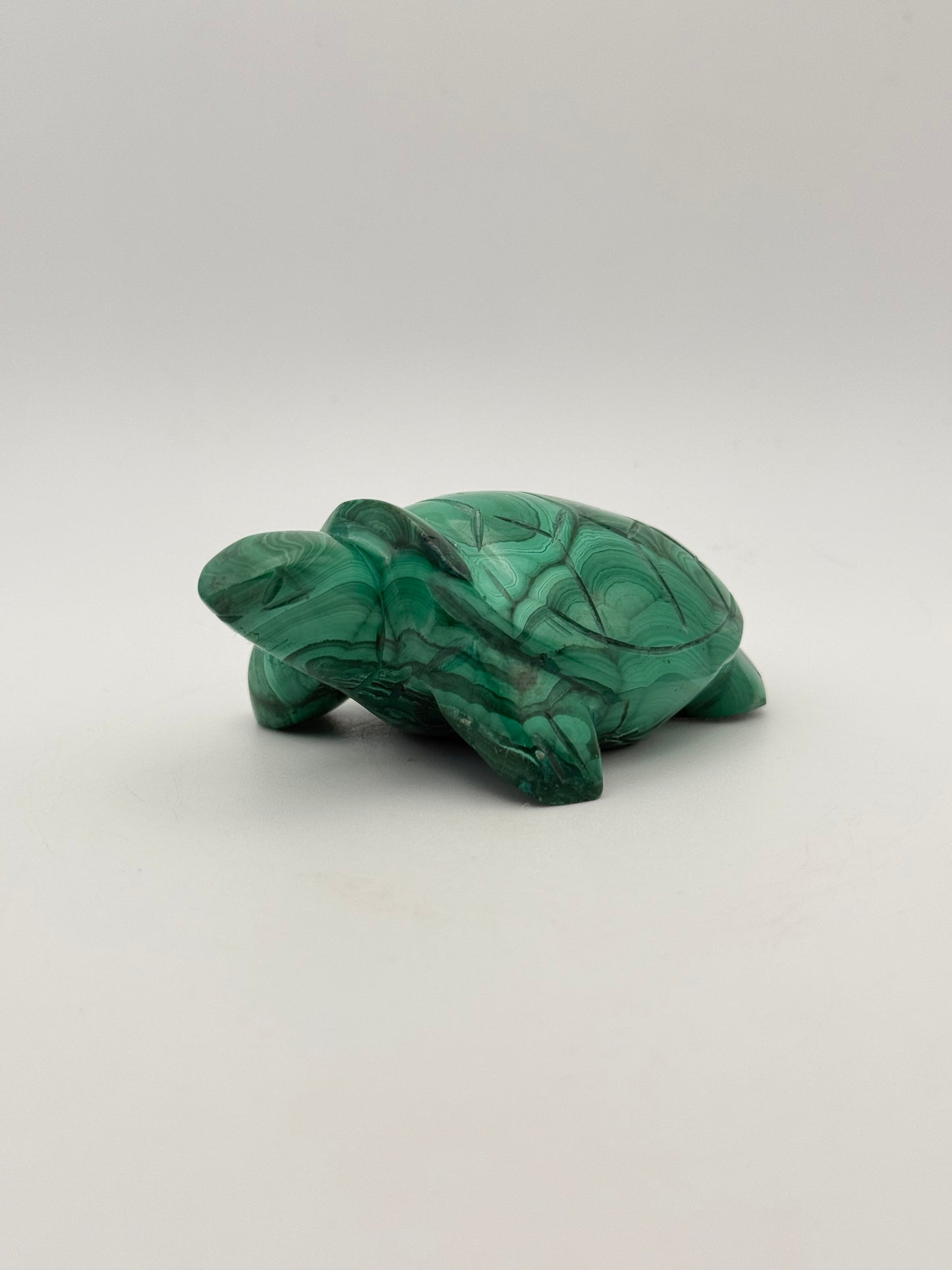 Vibrant green malachite stone carving of a turtle.