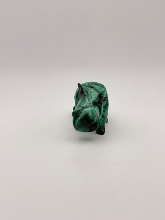 Vibrant green malachite carving of a rhino.