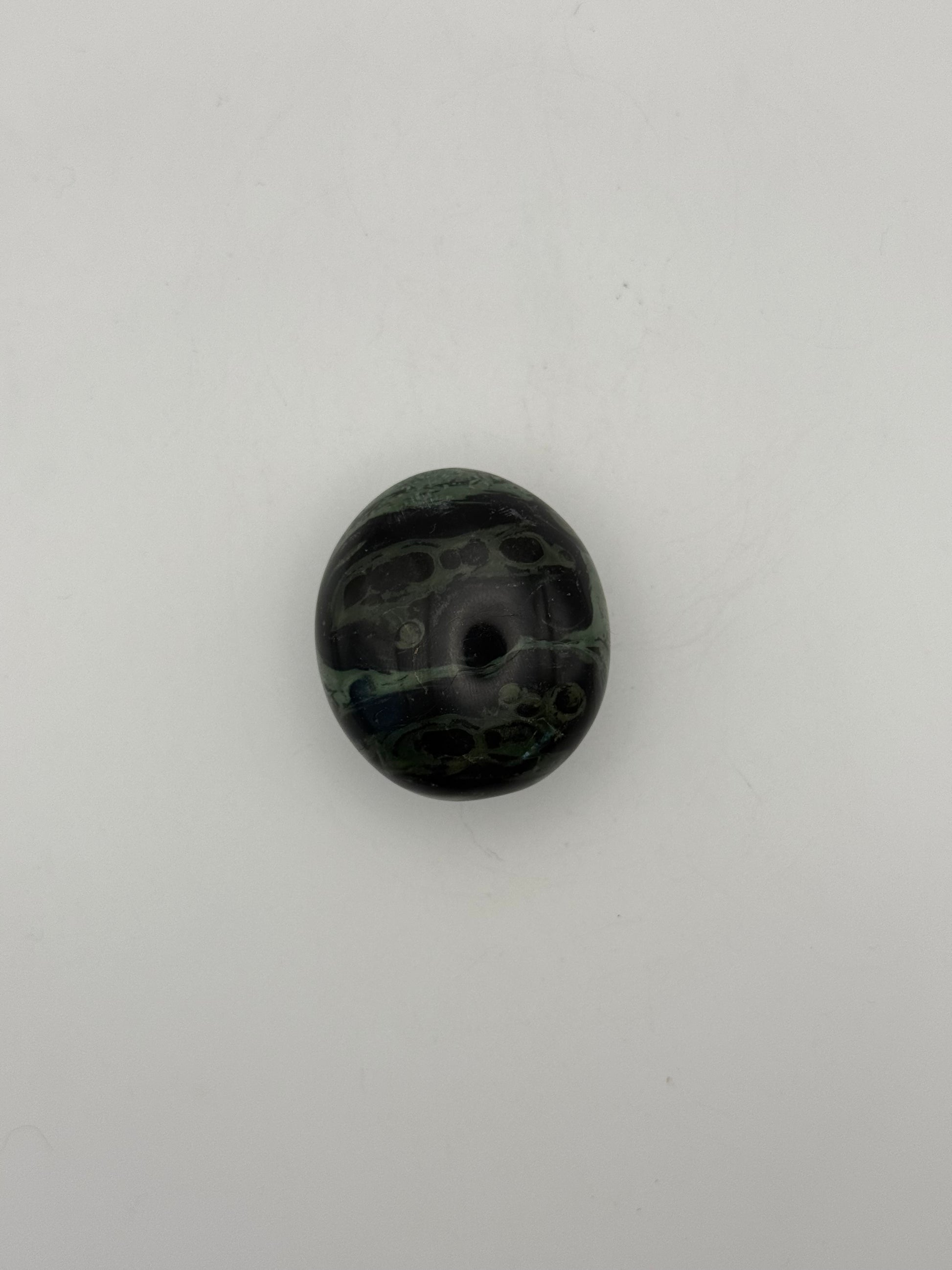 Polished kambaba jasper palm stone.