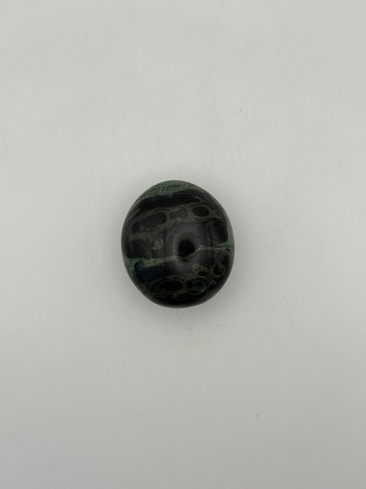 Polished kambaba jasper palm stone.