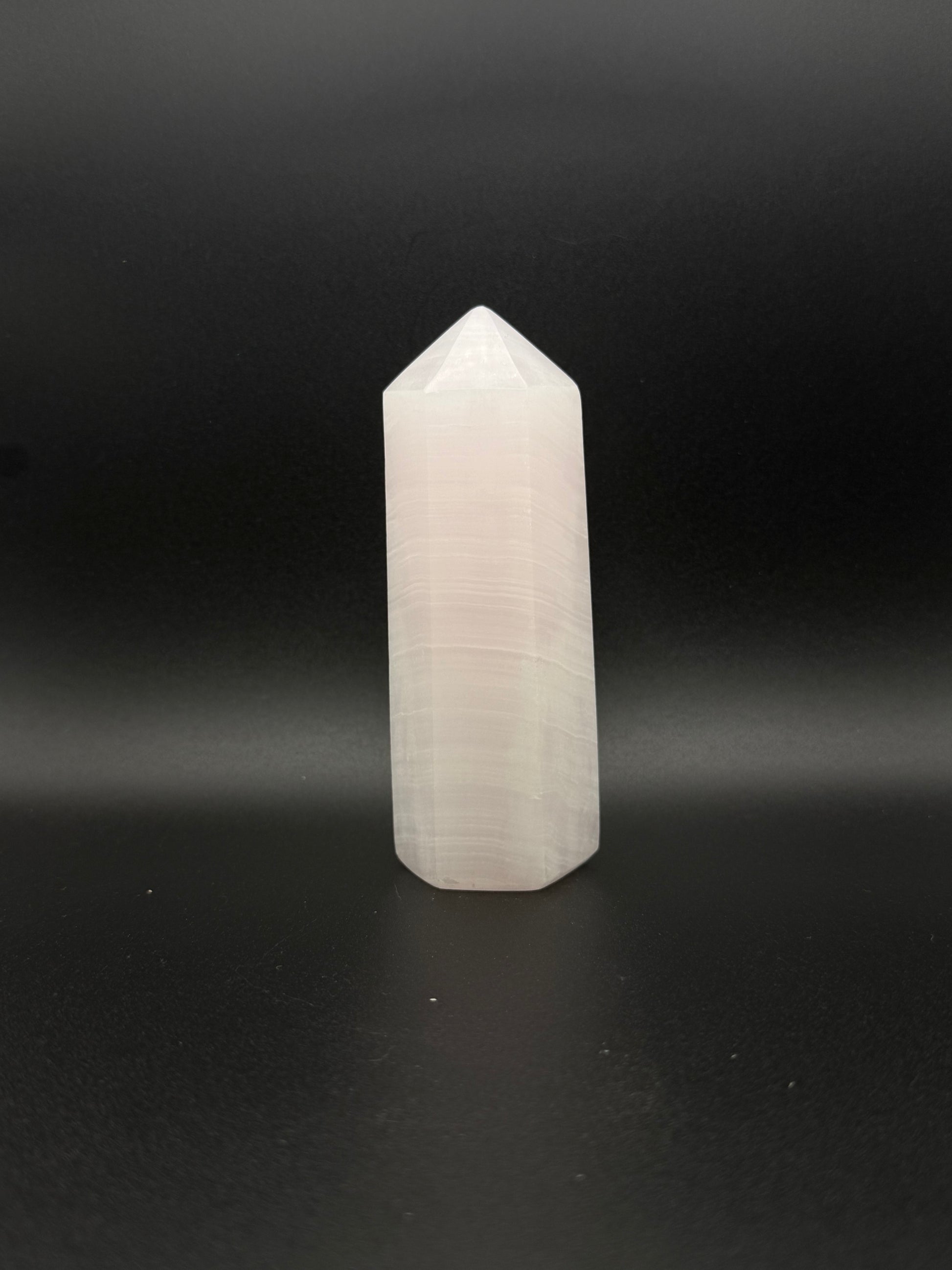 Polished pink calcite tower. Pink calcite glows under uv light.