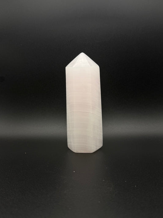 Polished pink calcite tower. Pink calcite glows under uv light.