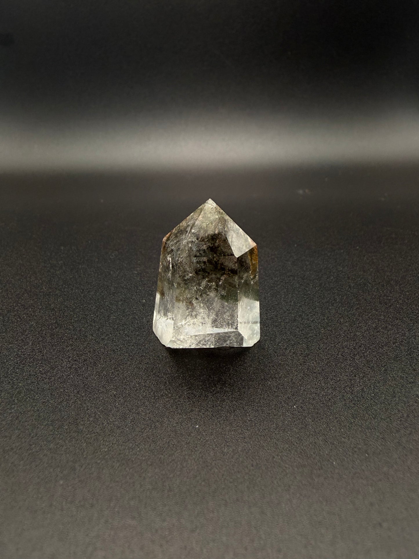 Polished garden quartz crystal tower with six sides.
