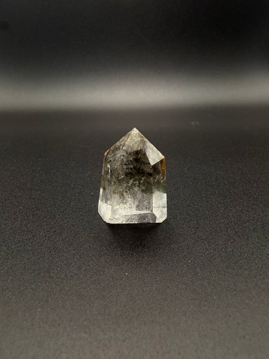 Polished garden quartz crystal tower with six sides.