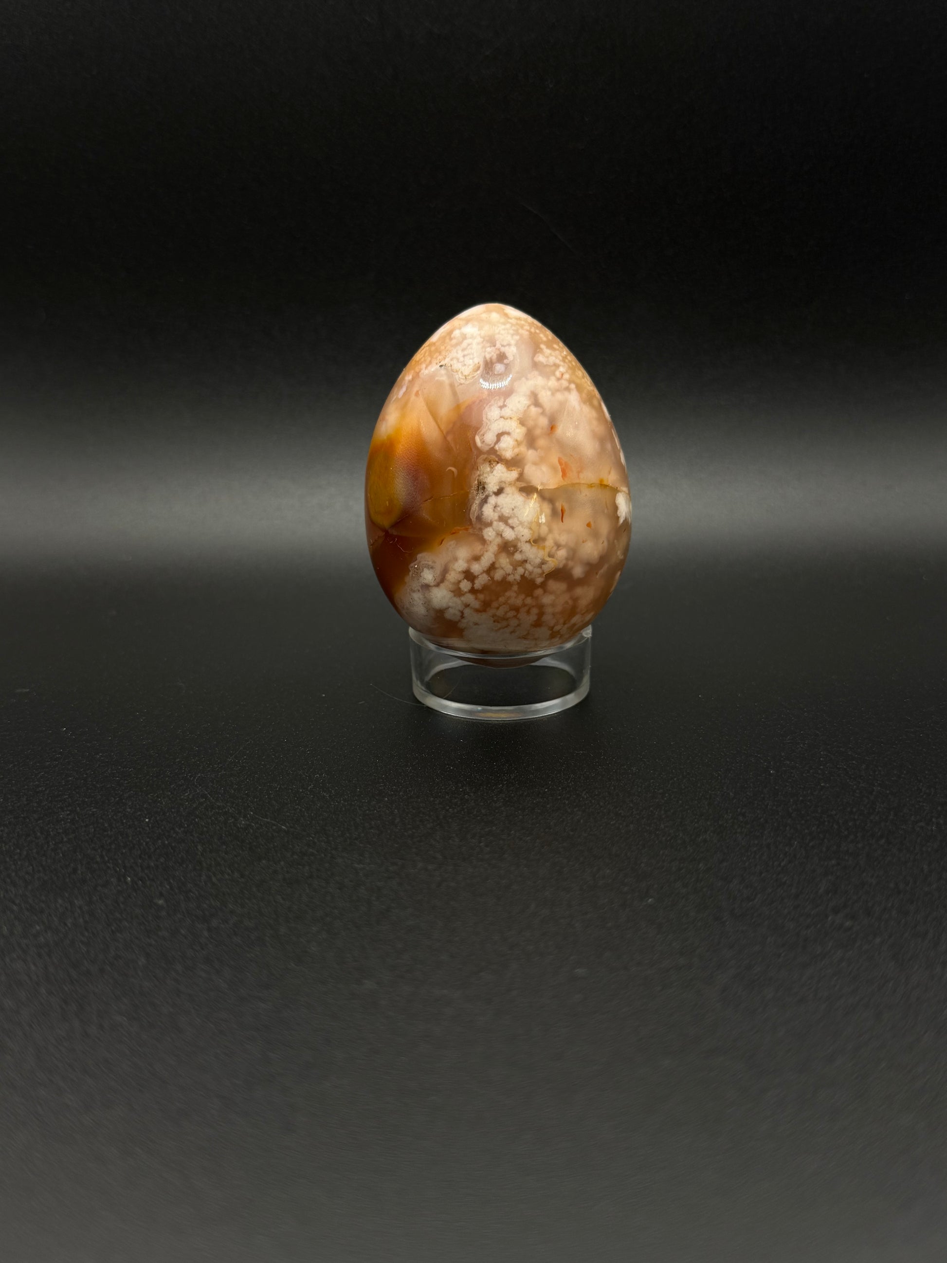 Flower Agate polished crystal in the shape of an egg.