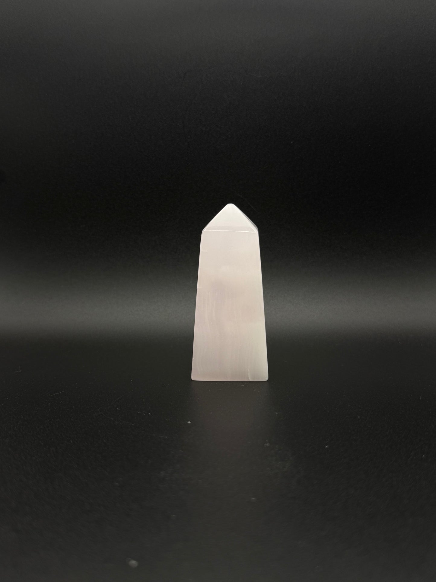 Polished pink calcite tower. Pink calcite glows under uv light.