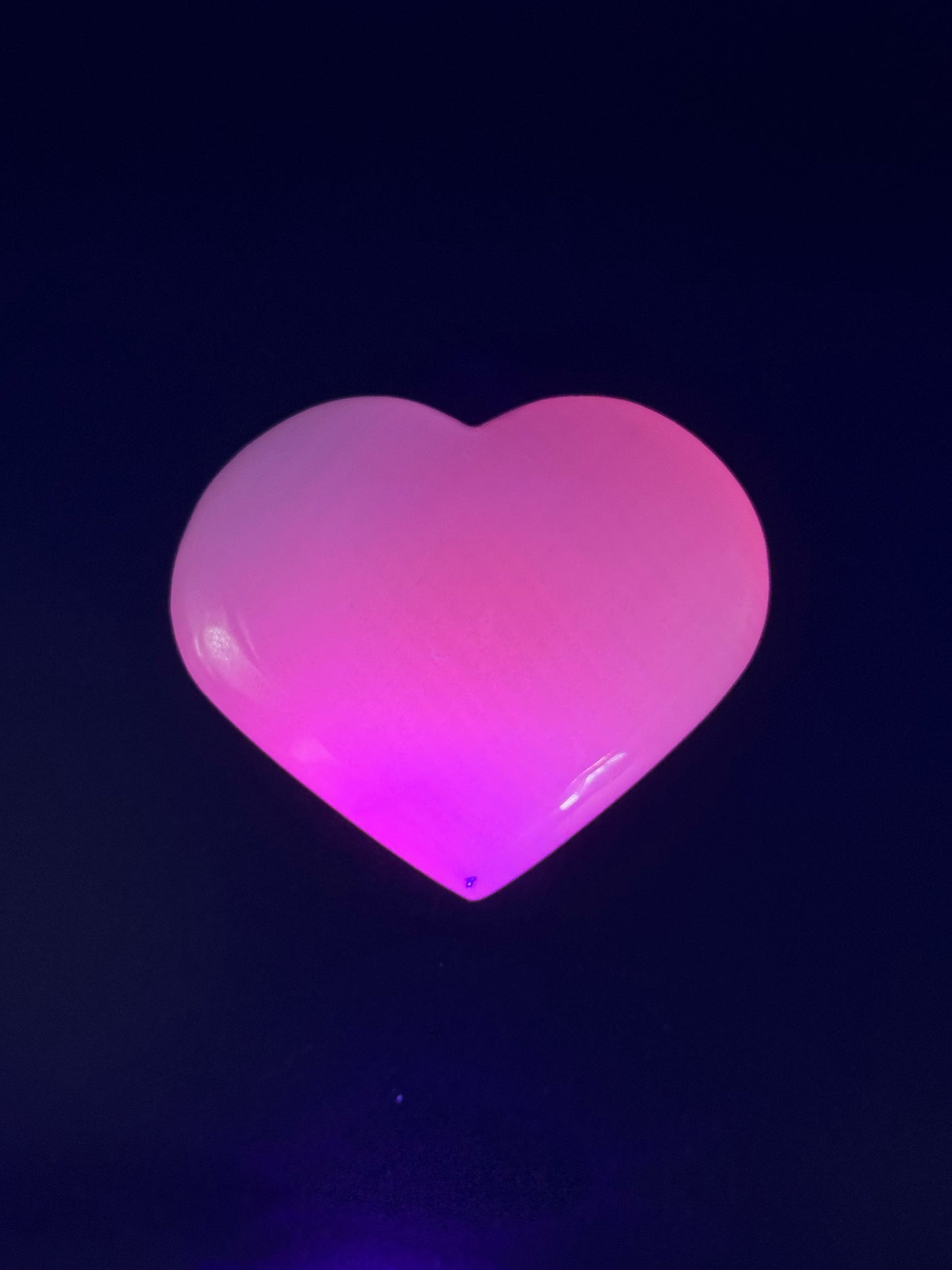 Polished pink calcite heart. Pink calcite glows under uv light.