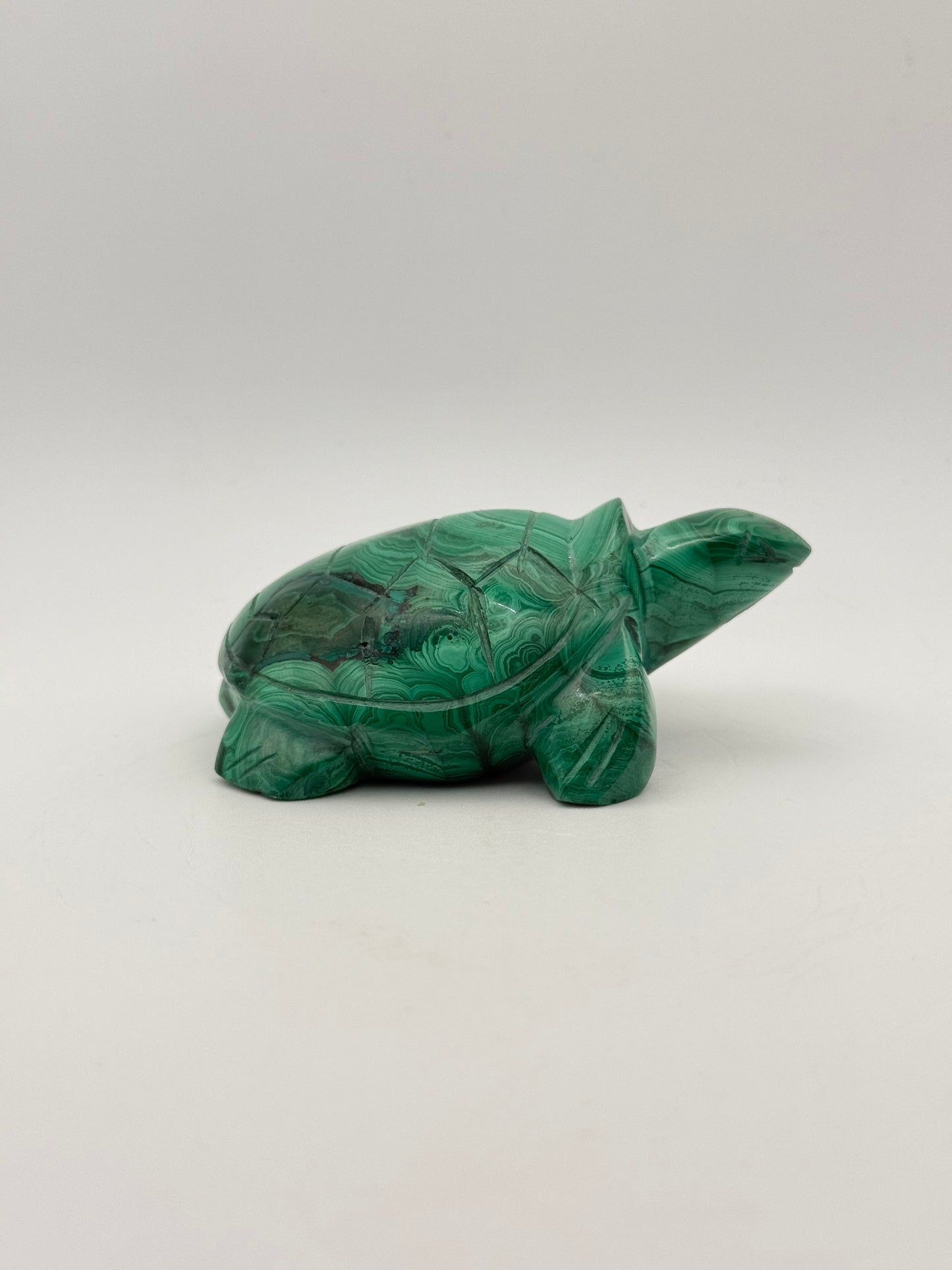 Vibrant green malachite stone carving of a turtle.