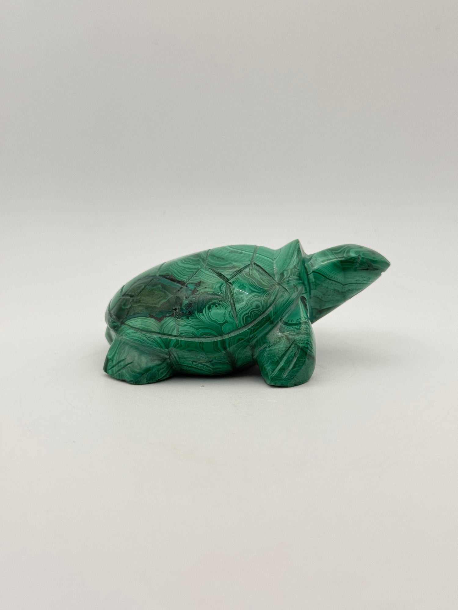Vibrant green malachite stone carving of a turtle.
