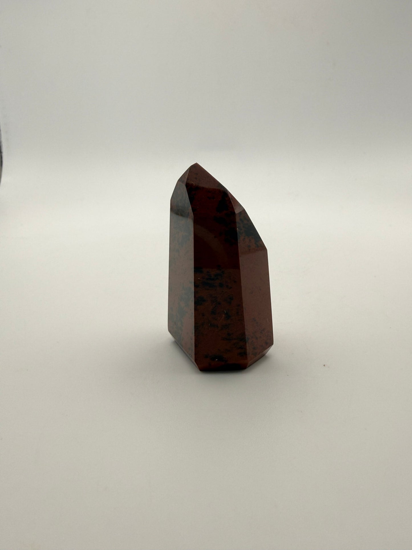 Polished mahogany obsidian tower with six sides.