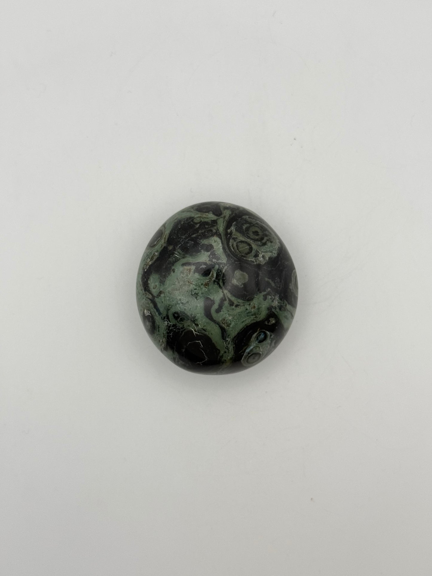 Polished kambaba jasper palm stone.
