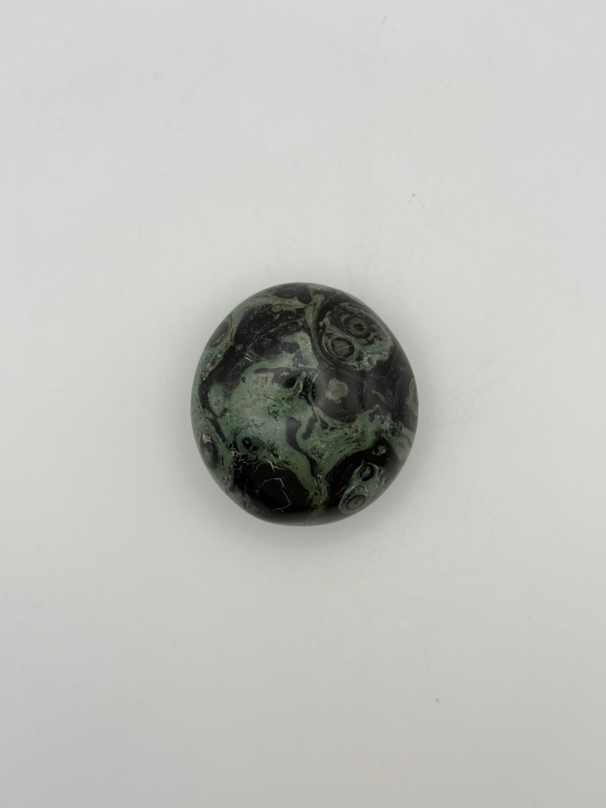 Polished kambaba jasper palm stone.