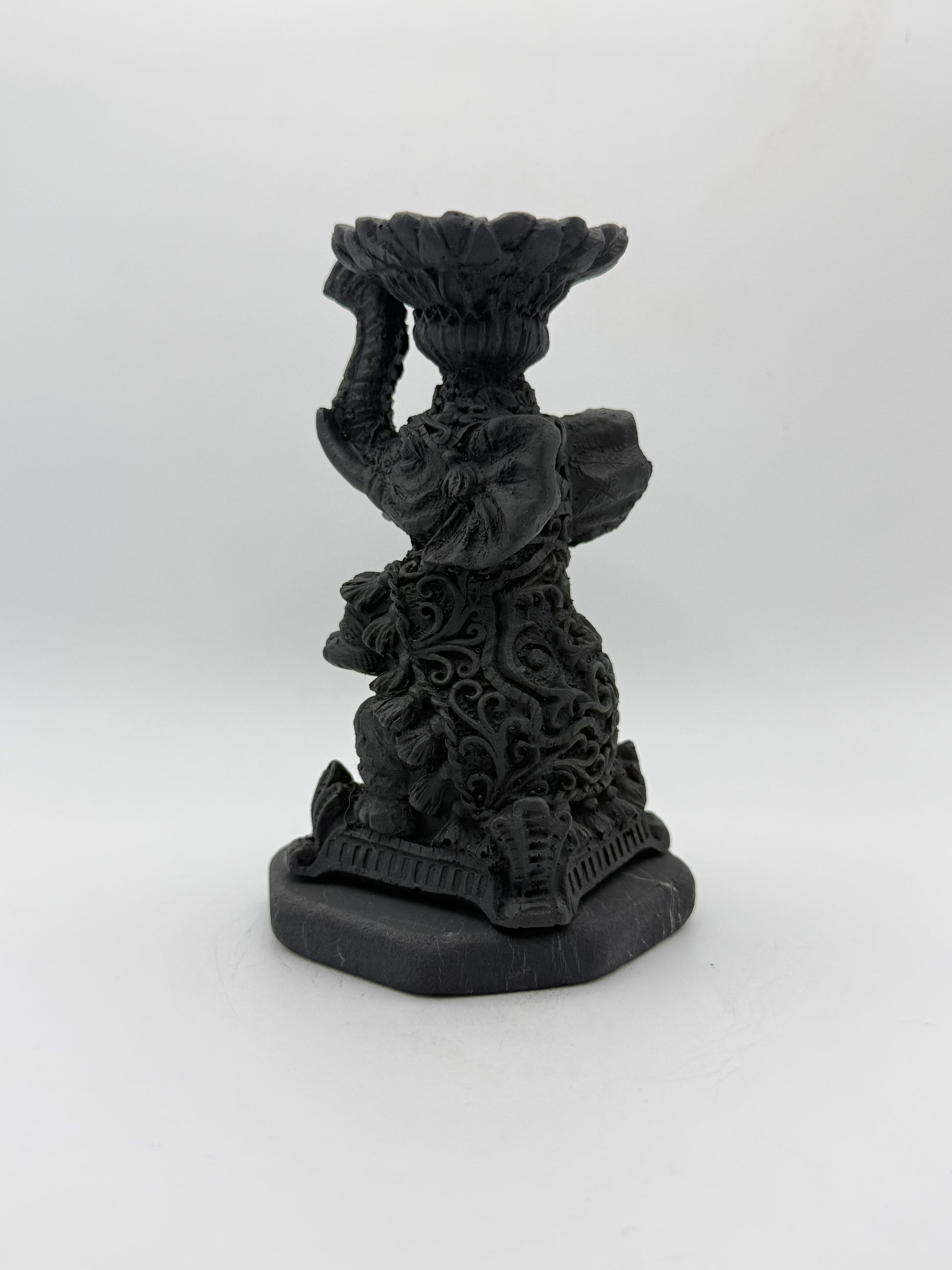 Shungite carving of an elephant that can be used as a candle holder.