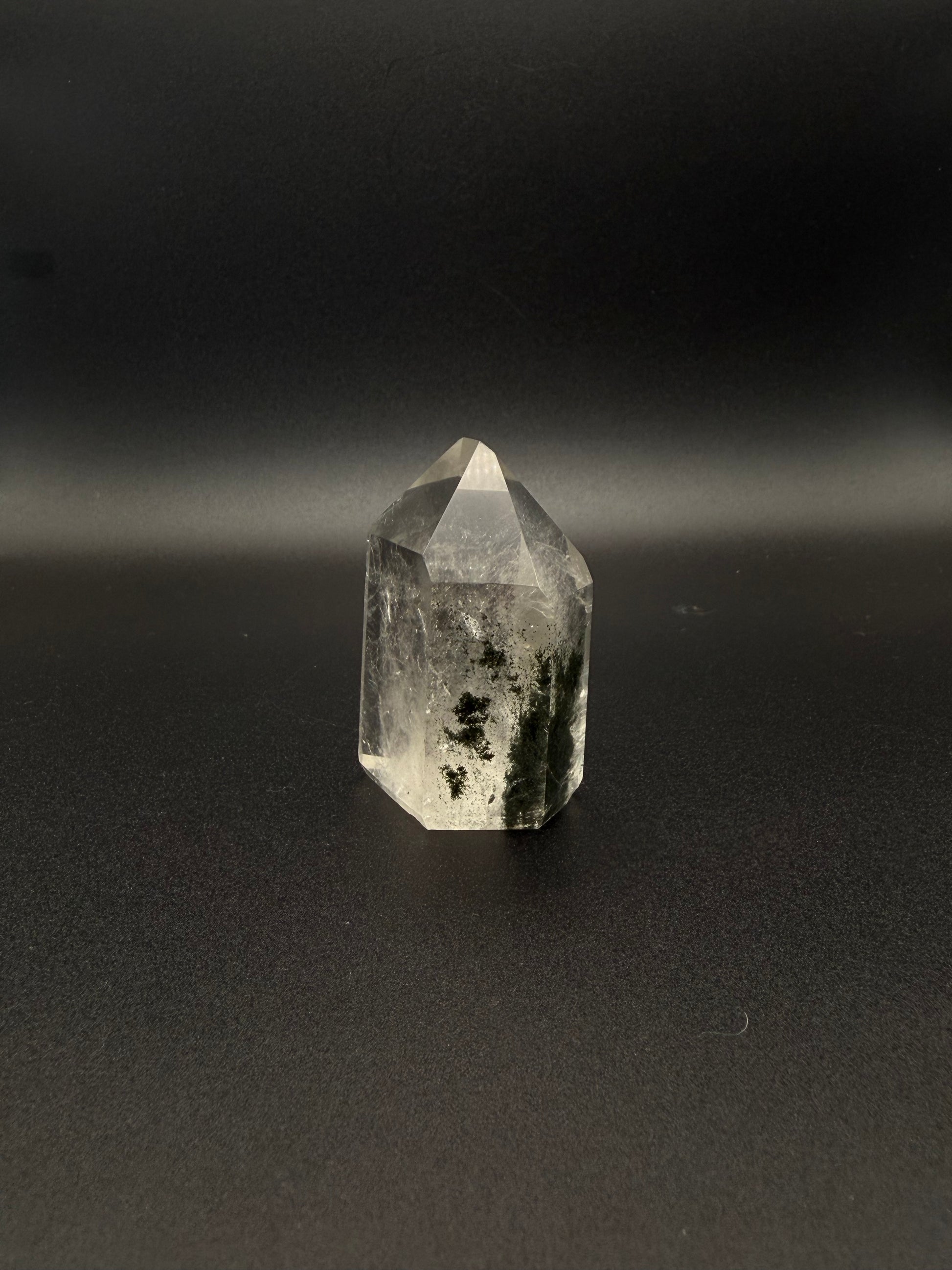 Polished garden quartz crystal tower with six sides.