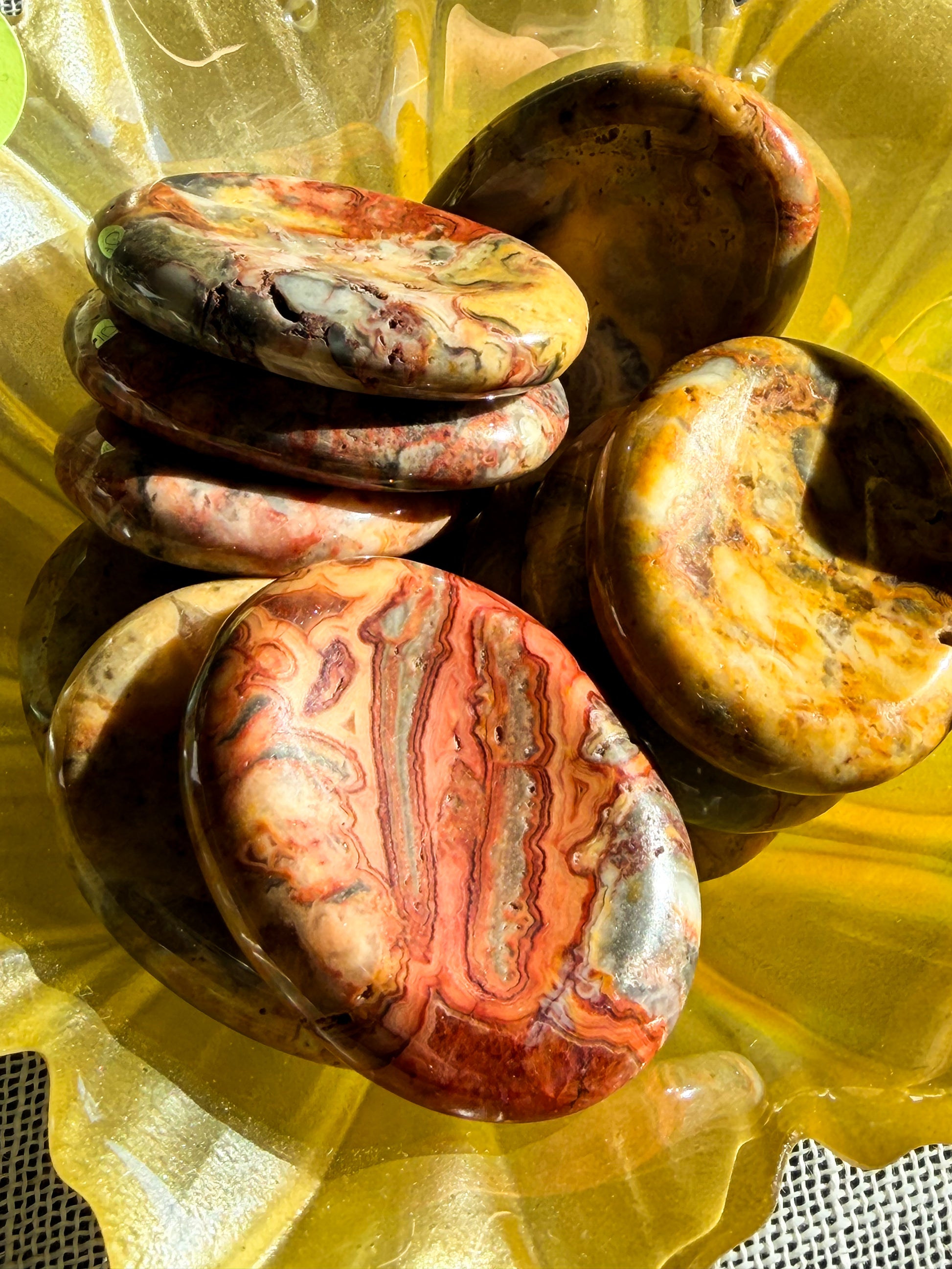 Yellow crazy lace agate worry stones.